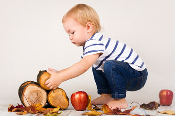 Little child playing with blocks of wood