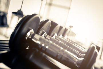 Obraz na płótnie Canvas Rows of dumbbells in the gym with hign contrast and monochrome color tone