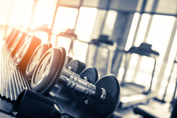 Fototapeta premium Rows of dumbbells in the gym with hign contrast and monochrome color tone