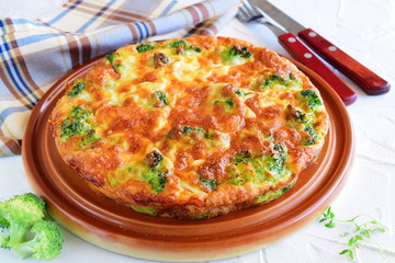 Broccoli pie on a brown ceramic plate. Healthy eating concept