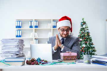 Young businessman celebrating christmas in the office