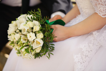 Obraz na płótnie Canvas Bride holding bouquet of fresh flowers. Wedding concept