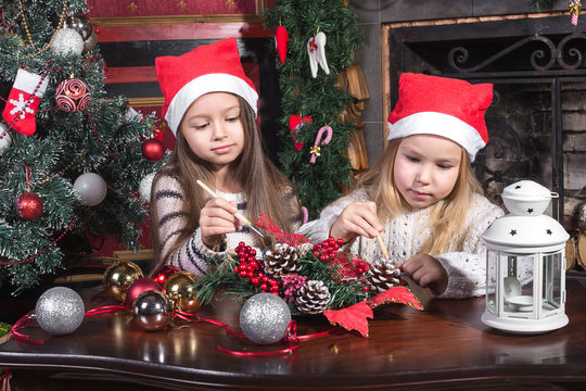 beautiful girls decorating christmas toys