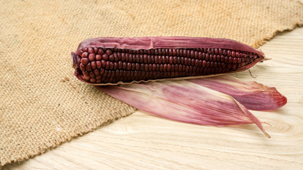 Purple corn on a wooden table.