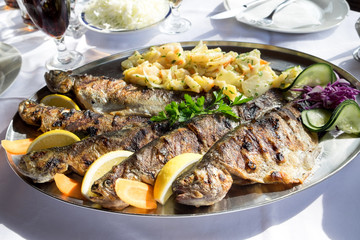 The traditional dish of the central Serbia is a grilled mountain trout served with potato and onion salad, garlic and lemon