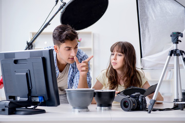 Young photographer working in photo studio