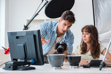 Young photographer working in photo studio