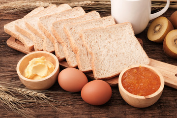 Slice whole wheat bread, butter and orange jam.