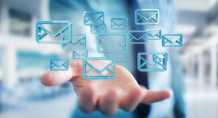 Businessman holding and touching floating emails 3D rendering