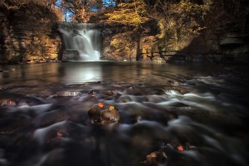 Fototapeta premium Neath Abbey waterfalls An almost unknown man made industrial waterfalls near Neath Abbey on the river Clydach, Skewen, South Wales, UK