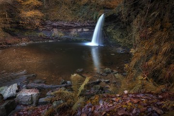 Fototapeta na wymiar Sgwd Gwladus waterfall Pontneddfechan Known either as Lady Falls in English or Sgwd Gwladus in Welsh, on the river Afon Pyrddin near Pontneddfechan, South Wales, UK, known as Waterfall Country