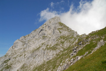 Summit of Admonter Reichenstein in the alps, Austria, with large clouds on the backside