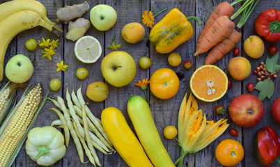 Composition of yellow vegetables and fruits - banana, corn, lemon, plum, apricot, pepper, zucchini, tomato, asparagus beans, ginger Healthy food Top view Flat lay