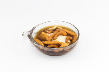 Soft bean curd in hot ginger syrup in transparent bowl