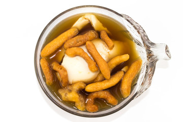 Soft bean curd in hot ginger syrup in transparent bowl