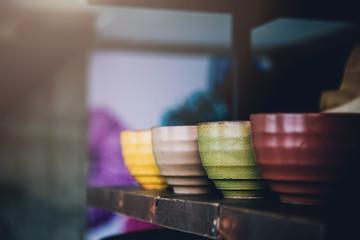 old handmade bowl on shelf stack with blur background