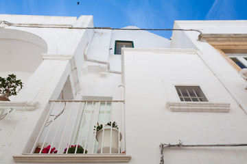 Locorotondo (Puglia, Italy) - View of the little picturesque village in south Italy. The white color of its houses represents the background of its baroque architecture built using the local stones.