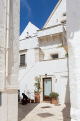 Locorotondo (Puglia, Italy) - View of the little picturesque village in south Italy. The white color of its houses represents the background of its baroque architecture built using the local stones.