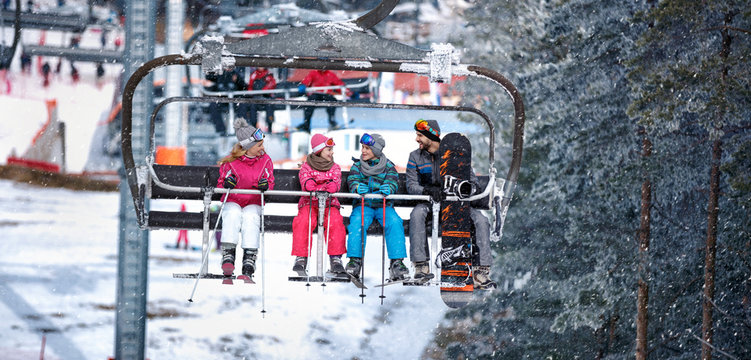 People are lifting on ski-lift in the mountains