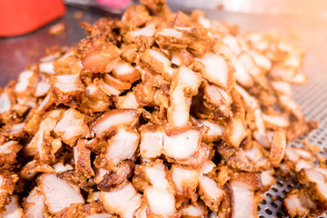 closeup Pile cooked fried pork in the market .