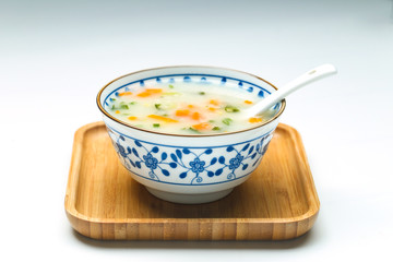 vegetable porridge in blue and white porcelain bowl