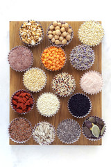 Various superfoods, seeds, cereals, grains on a  white table. Healthy eating concept. Flat lay