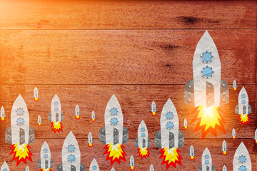 rocket papercut shape on old wood plank with rustic texture background