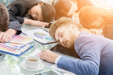 businessmen and businesswomen exhausted and sleep during a meeting business concept - obrazy, fototapety, plakaty