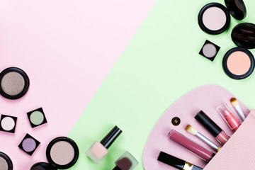 Beauty products and fashion accessories flat lay on pastel background, top view