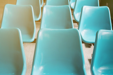 Fototapeta premium Rows of blue chairs of patients waiting for a doctor in the clinic at the hospital.
