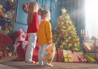 sisters near Christmas tree