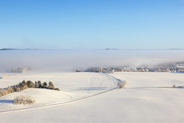 Aerial view of a winter rural landscape with a road