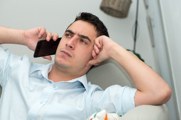 Fototapeta premium young man calling on his mobile phone with a serious expression