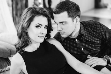 Expressive look of a brunette elegant woman embraced by her lovi