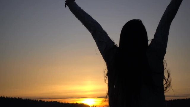 Young asian Woman Dancing at Sunset in mountains on Vacation