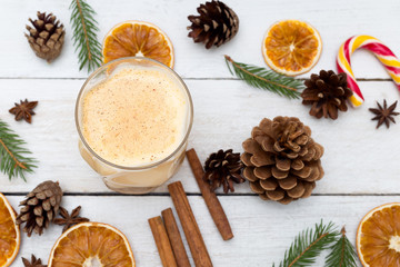 Eggnog with cinnamon and nutmeg at christmas time. Flat lay