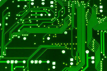 Green computer circuit board close up.