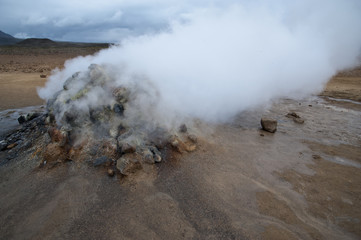 Hverarönd, Iceland. Hot vapors in a typical Icelandic landscape, a wild nature of rocks and shrubs, rivers and lakes.