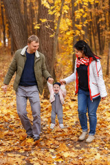 Fototapeta premium parents walk and play with little daughter