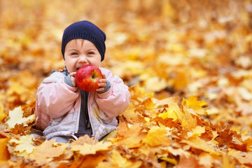 little laughing girl in the autumn park