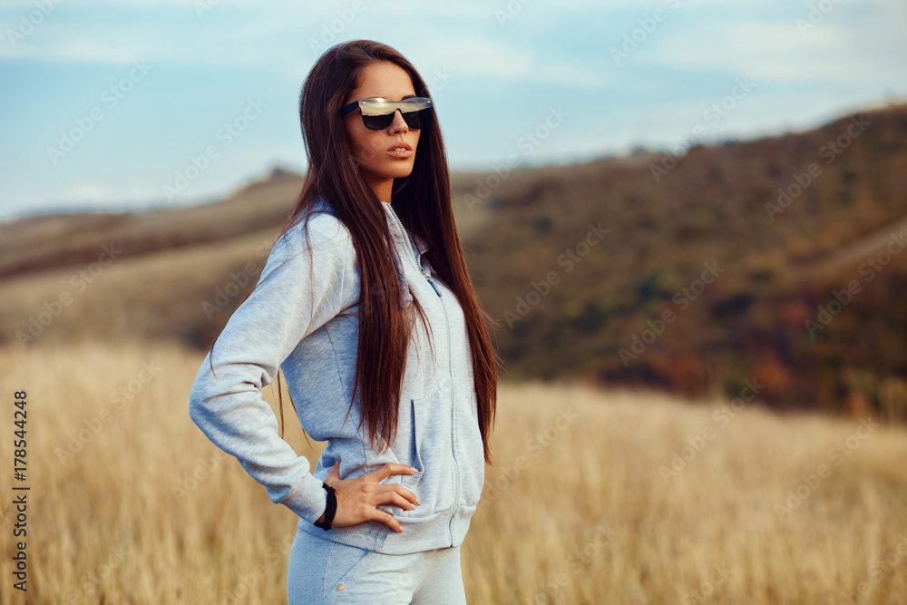 Canvas Prints Women in sports clothes and sunglasses pose in nature