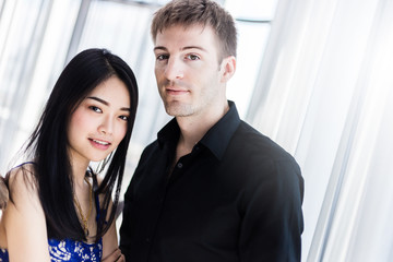 Portrait of beautiful young couple looking at camera