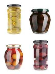 Jars with different canned olives on white background