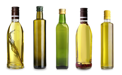 Bottles with different olive oil on white background