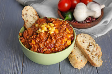Bowl with chili con carne on table
