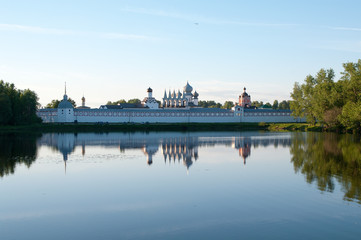 The reflection of the Tikhvin Assumption monastery in the waters of the Tabory pond, Tikhvin, Leningrad region, Russian Federation