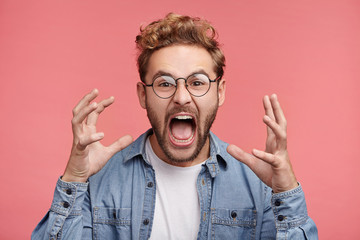 Emotional outraged man gestures angrily, being irritated with loud noise in next room, need to do...