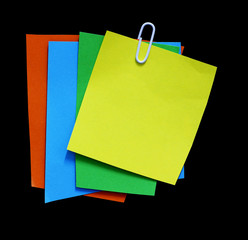 pieces of torn note paper on black. copy space
