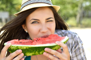 Happy young woman eating watermelon on the beach. Youth lifestyle. Happiness, joy, holiday, beach,...