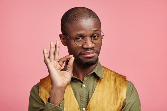 Indoor picture of confident serious male with dark pure skin makes ok gesture, being satisfied with everything, hasn`t any rejections. Satisfied Afro American man isolated over pink background